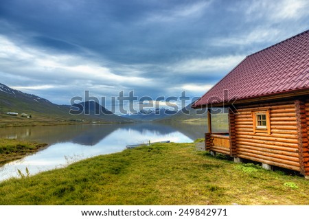 Log cabin on a scenic lake in Northern Iceland