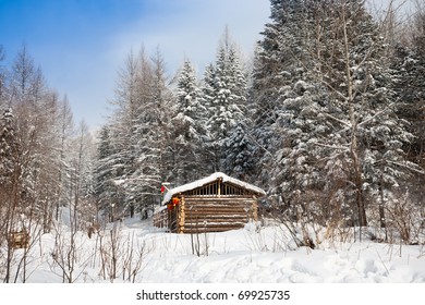 log cabin in winter forest