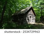 A log chapel built in a sparsely populated area in the forest in the late 18th century in Canada. It was used for religious services and other gatherings 