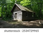 A log chapel built in a sparsely populated area in the forest in the late 18th century in Canada. It was used for religious services and other gatherings 