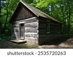 A log chapel built in a sparsely populated area in the forest in the late 18th century in Canada. It was used for religious services and other gatherings 