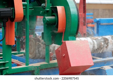 Log Cutting With Band Saw Machine At Sawmill. Selective Focus.