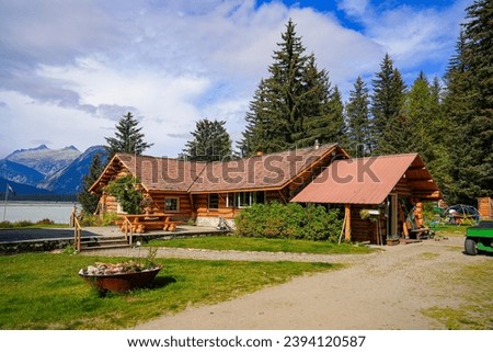 Log house of the Historic Taku Glacier Lodge, a wooden cabin located on the shores of a melt water lake in the mountains north of the Alaskan capital city Juneau