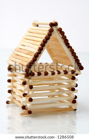 Log house from matches pattern isolated on white paper