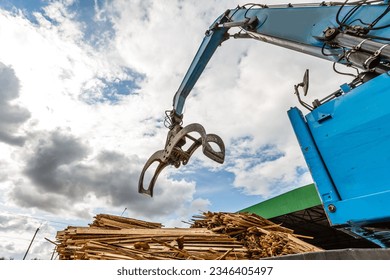 Log loader or forestry machine loads a log truck