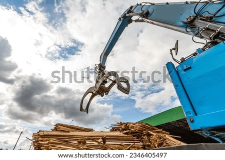 Log loader or forestry machine loads a log truck