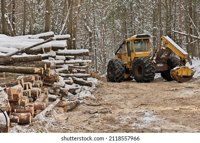 Log or Logging Skidder with Freshly Harvested and piled timber logs