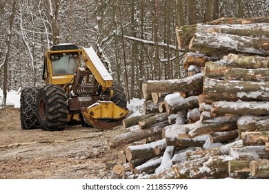 Log or Logging Skidder with Freshly Harvested and piled timber logs