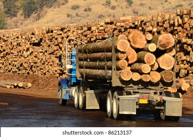 A Log Truck Delivers Its Load To A Sawmill In Oregon