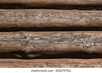 Log wall of a dark wooden blockhouse house close-up.