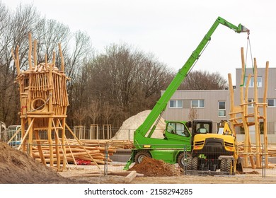 Log Wooden Construction. Wood Log Rabiia Playhouse installation. Crane install  Children Slide Playground in Urban Place of residential area.
