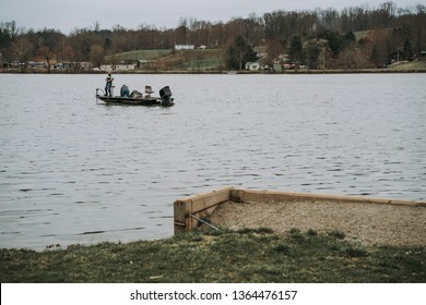Logan, Ohio / USA - 4/6/2019: Two Men Boat Fishing On Lake Logan