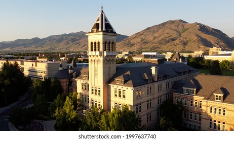 Logan, Utah - June 14, 2021: Utah State University (USU) Old Main Building at sunset with mountains