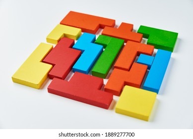 Logical thinking concept. Different shapes colorful wooden blocks on a white background