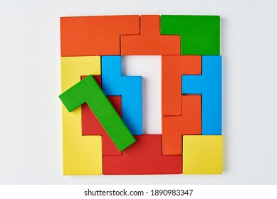 Logical thinking and finishing task concept. Different shapes colorful wooden blocks on a white background
