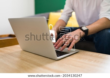 Login into my online account. Adult man typing on the laptop his username and password 