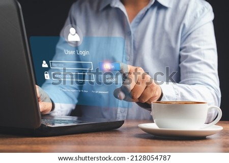 Login page username and password on a virtual screen. Businessman touching login button to the network system