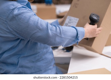 logistic shipping online orders concept. close up of warehouse worker scanning barcode on package box for tracking delivery, e-commerce. SME. - Shutterstock ID 2281504215