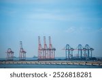 Logistic shipping quay boat Engineering crane depot at logistic export terminal control. Warehouse freight background container yard loading quayside harbor port. Logistics seascape shipping portal