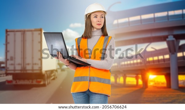Logistic transport. Track next to\
logistician. Blurred truck on roadside. Woman with laptop.\
Logistics center dispatcher. Concept work on choice of logistics\
warehouse. Automobile\
transportation.