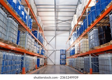 Logistic warehouse. Storehouse with barrels on racks. Multi-tier storage shelves in hangar. Warehouse without people. Place to store barrels and cisterns. Logistic warehouse in industrial building.
