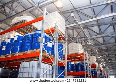 Logistic warehouse. Storehouse with shelving. Storage racks. Warehouse interior with barrels. Place to storage petrolium. Storehouse in manufactory building. Petrolium barrels are stored in hangar