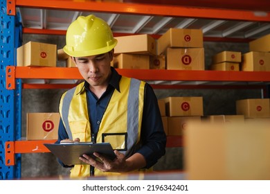 Logistic workers are checking and preparing the product parcel cardboard box in warehouse.