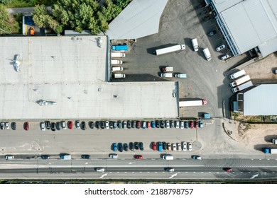 Logistics Center In Industrial Area, View From Above. Trucks Loading In The Distribution Hub. Drone Photo.