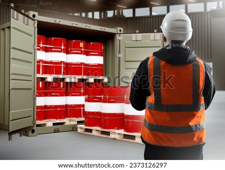 Logistics of chemical products. Man near container with barrels. Sea container with chemical products. Man is logistician in industrial building. Process of loading chemical substances into barrels