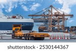 Logistics container dock cargo yard with working crane bridge in shipyard with transport logistic import export background.