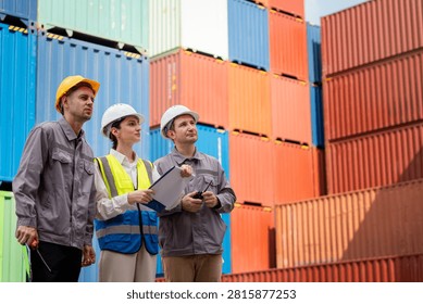 Logistics engineers and inspector looking at cargo containers, International port supervisors checking shipping yard operations, Diverse industrial workers planning freight distribution at dock