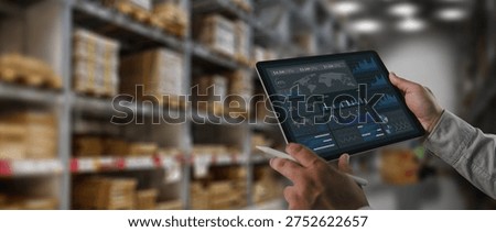 Logistics manager analyzing supply chain data dashboard on tablet inside warehouse storage facility. Concept of logistics analytics, inventory monitoring, digital warehouse management and technology driven supply chain operations.