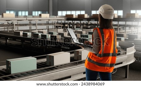 Logistics Manager Overseeing Automated Warehouse Operations with Laptop