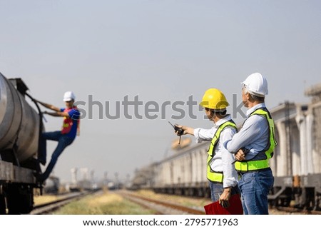 Logistics managers inspecting cargo train operations at railway freight yard, Engineer team supervising rail transport and freight operations at commercial freight terminal