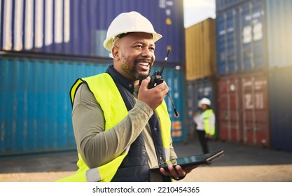 Logistics, radio and a black man in shipping container yard with tablet. Industrial cargo area, happy transport worker talking on walkie talkie in safety gear and working for global freight industry. - Powered by Shutterstock