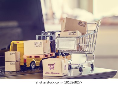 Logistics, Supply Chain And Delivery Service For E-commerce, Online Shopping Concept : Boxes, Shopping Cart, Fork-lift Truck, Delivery Van On A Laptop Computer, Depicts Using Internet To Order Goods
