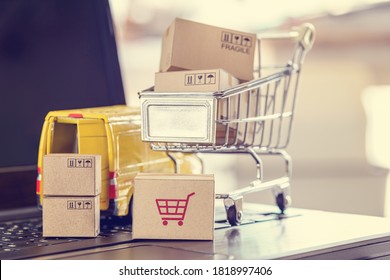 Logistics, Supply Chain And Shipment Service For E-commerce, Online Shopping Concept : Boxes Of Goods, Trolley, Delivery Van On A Laptop Computer, Depicts Customers Uses Internet To Order  Buy Things