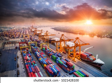 Logistics and transportation of Container Cargo ship and Cargo plane with working crane bridge in shipyard at sunrise, logistic import export and transport industry background - Shutterstock ID 1021428100