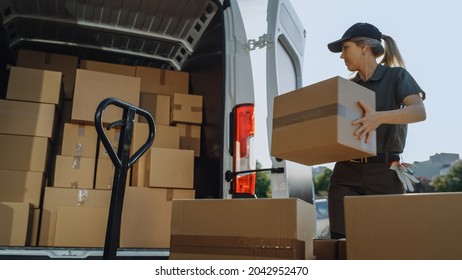 Logistics Warehouse: Female Worker Loading Delivery Truck with Cardboard Boxes, Online Orders, Purchases, E-Commerce Goods. Happy Professional Works Hard to Deliver All the Products. - Powered by Shutterstock