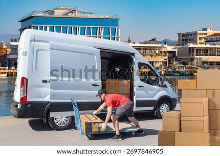 Logistics worker loads parcels from van onto trolley, courier service operations near city waterfront, shipping and distribution tasks.