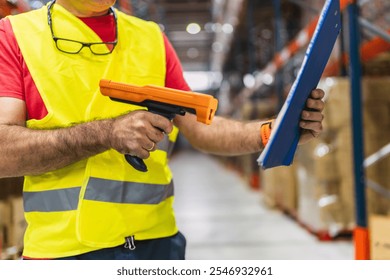 Logistics worker scanning barcodes and checking inventory in a large distribution warehouse - Powered by Shutterstock - Get 15% off with code: PIKWIZARD15