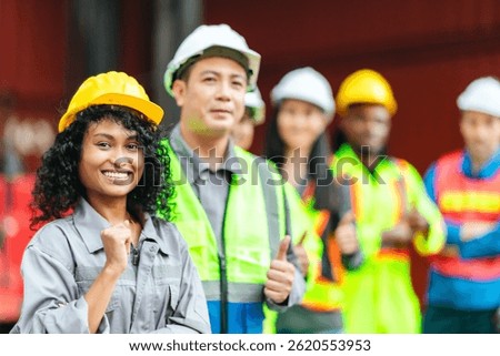 Logistics workers from different teams collaborate at a shipping container yard, showcasing teamwork and coordination in the supply chain and transportation industry.