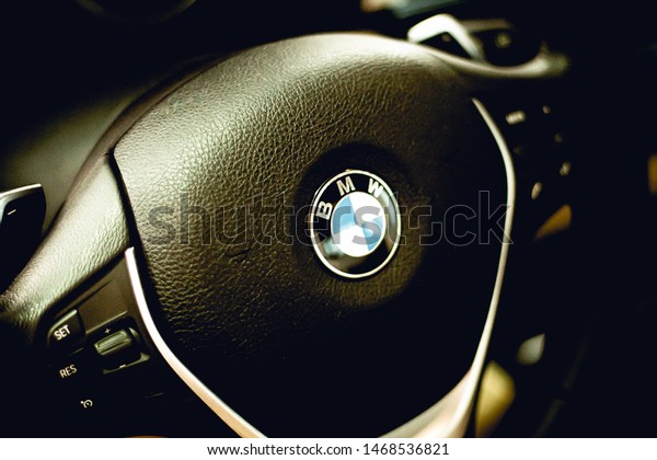 \
Logo of Bmw.\
Photograph of the interior of a bmw car showing the company logo on\
the wheel. Model bmw 328i year 2014. Brasilia, Federal District -\
Brazil. Circa, June, 2019.\
