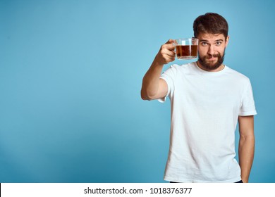 Logo, Drink, Man In A White T-shirt With A Mug Of Tea On A Blue Background                               