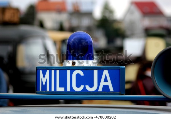 Logo of the former Polish police (militia) /\
illuminated sign police.