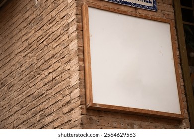 Logo mockup in acrylic frame with rustic wooden border typical of restaurant on brick wall