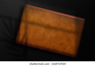 Logo mockup on leather box On a black background with shadows
