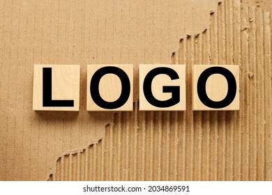 Logo. Wooden Blocks On Craft Background From Torn Paper