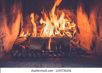 Logs Burning In A Fireplace Stove. Close Up.