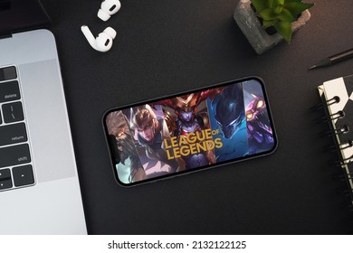 LOL League of Legends game app on the smartphone screen on black background table. Office environment. Rio de Janeiro, RJ, Brazil. February 2022.